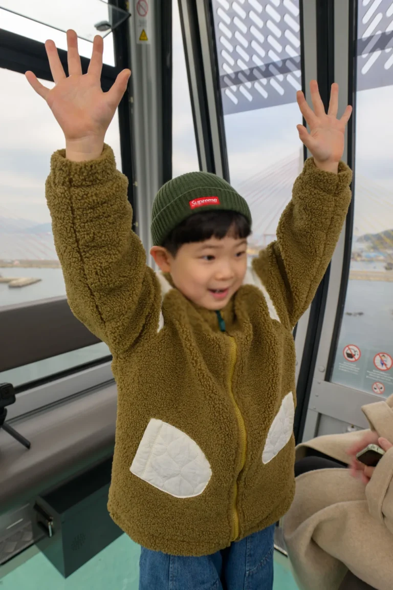 케이블카 캐빈 안에서 양팔 벌린 아들